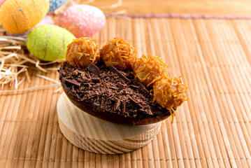 Chocolate filled easter eggs on easter wooden background, easter concept