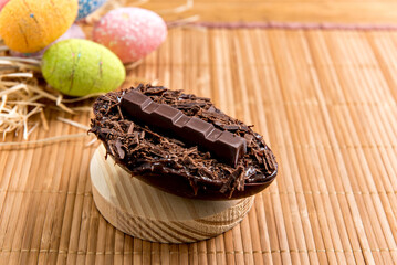Chocolate filled easter eggs on easter wooden background, easter concept