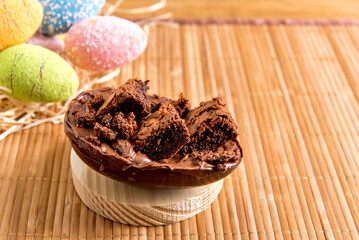 Chocolate filled easter eggs on easter wooden background, easter concept