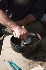 Male hand cleaning a seal in a brake hub.