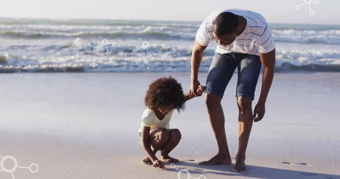 Animation of molecules over african american afather and son picking up shells on beach at sunset