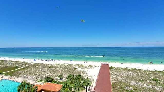 Clearwater Beach, Florida, USA | A crowded Florida beach with people sunbathing and enjoying beach activities and seagulls flying