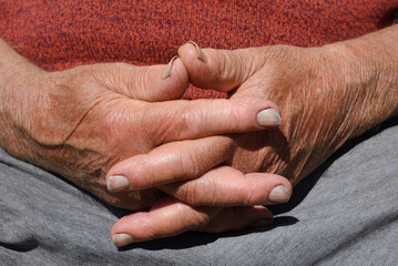 Dirty hands of an elderly man crossed, hands of a farmer at rest