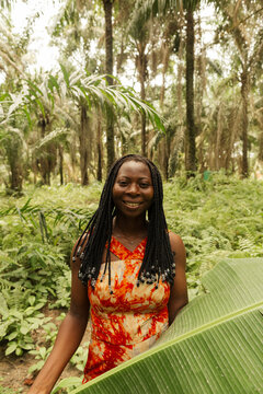 Portrait of a black African conservationist smiling outdoors in the field