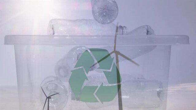 Animation of green recycling sign over box with plastic bottles and wind turbines