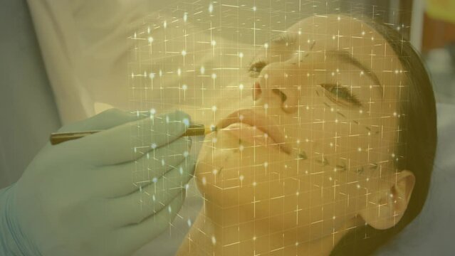 Animation of cube over hands of male doctor preparing woman to plastic surgery