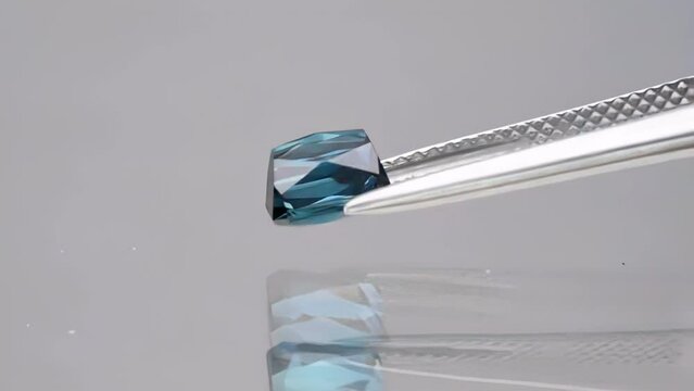 natural blue tourmaline indicolite baguette in the tweezers