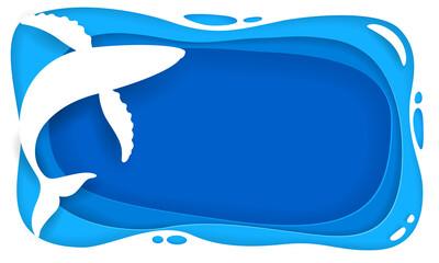 Cut paper depicting a blue whale swimming in the sea.