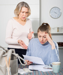 Mature woman having disagreement with her adult daughter for filling documents