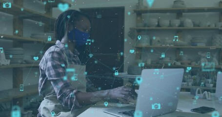 Animation of network of connections over african american woman with face mask doing pottery - Powered by Adobe