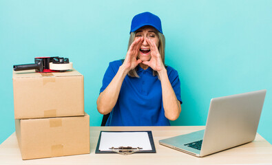 senior gray hair woman feeling happy,giving a big shout out with hands next to mouth. employee...