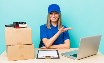 senior gray hair woman smiling cheerfully, feeling happy and showing a concept. employee packer...