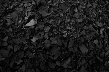 A heap of black natural coal, photo of coal mine background, texture. Natural energy sources. The world's main fuel source for electricity generation.	