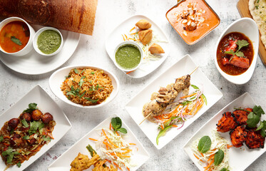 Top down of various appetising Indian dishes on table