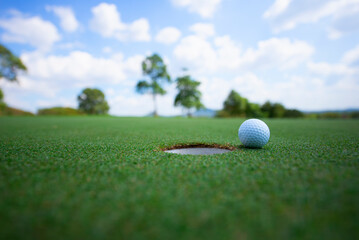 Golf ball on the beautiful green of the turf. Golf is a sport to play on the turf