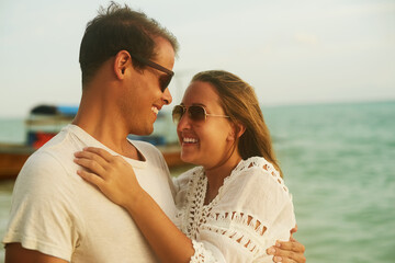Im lovin this. Shot of an affectionate young couple on the beach at sunset.