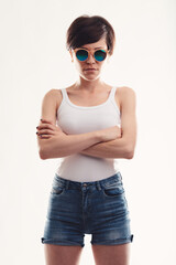 Trendy modern young woman with circular sunglasses or shades - obrazy, fototapety, plakaty