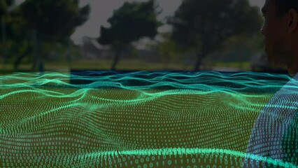 Animation of waves with binary coding over diverse football players on stadium - Powered by Adobe