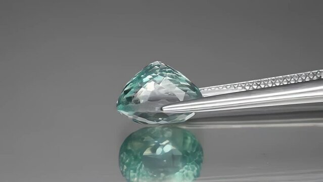 natural blue tourmaline indicolite oval cut in the tweezers