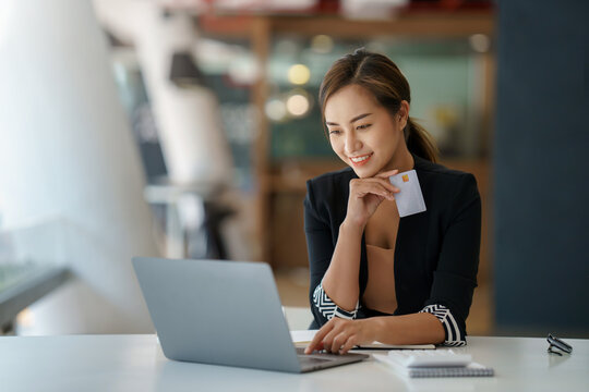Young Asian business woman using smartphone and credit card for online shopping. Online Payment.