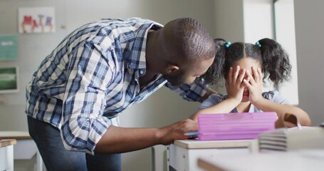 Video of african american male teacher supporting sad biracial girl