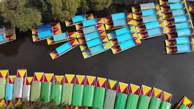 Aerial Drone Shot of Colorful Boats in Xochimilco. Tours by cannels with floating gardens in Mexico City CDMX, Mexico