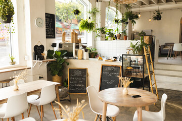 Interior of modern coffee shop with tables and chairs