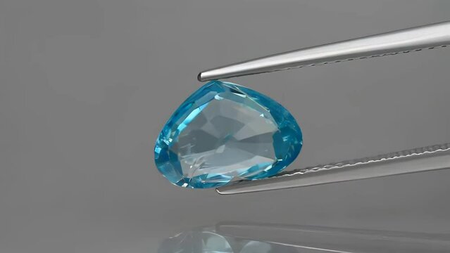 natural gemstone blue zircon heart cut in the tweezers