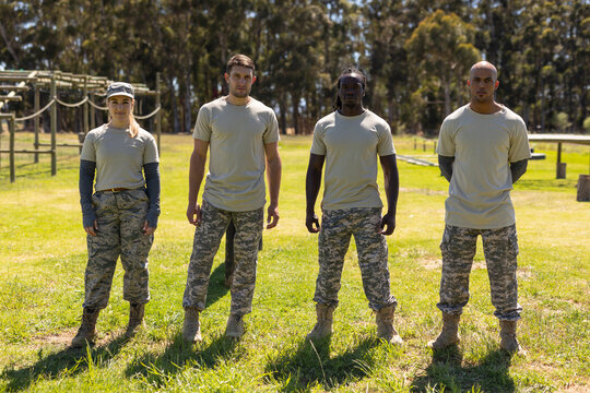 Portrait of group of male and female diverse soldiers standing at boot camp