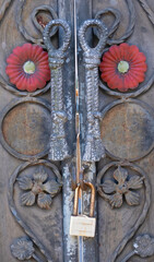 Lock hanging on iron door handles