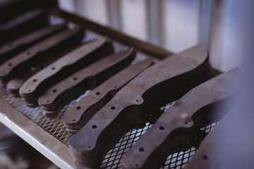 Close-up of metal of various shapes stacked on shelf in manufacturing industry