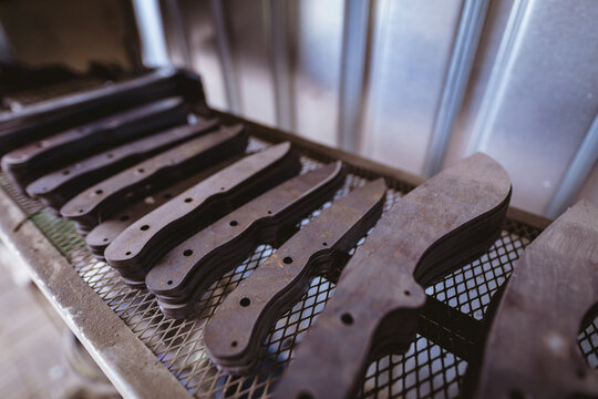 Close-up of metal of various shapes arranged on shelf in industry