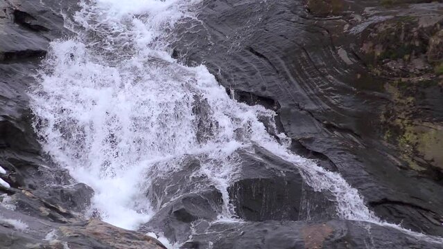 Slow motion waterfall. Water rolls down rock - 2