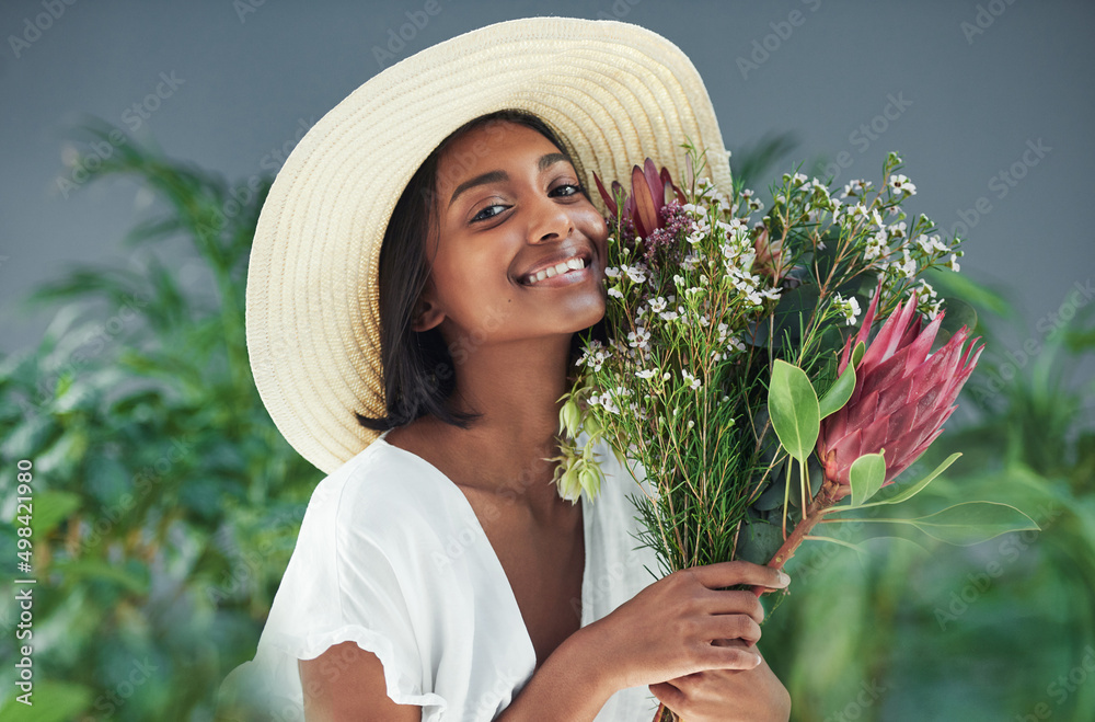 Poster Give me flowers and Ill be the happiest person. Cropped shot of a beautiful young woman smelling a bouquet of flowers.