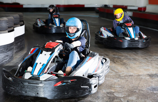 Young woman driving sport car for karting in a circuit lap in sport club