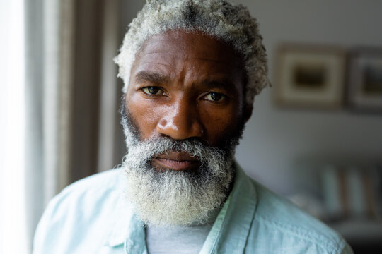 Portrait of confident bearded senior african american man at home