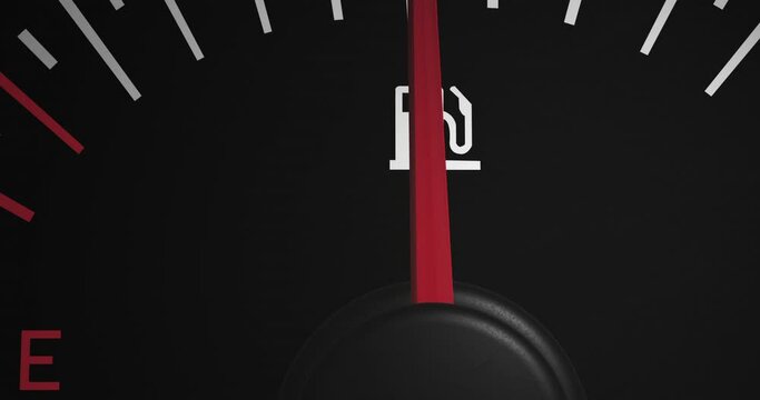 Animation of close up of fuel gauge moving over black background