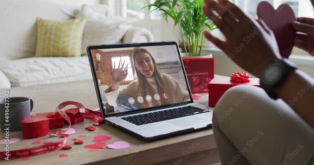 Poster Happy caucasian woman waving and making valentine's day video call on laptop