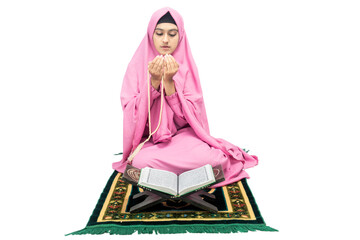 Asian Muslim woman in a veil sitting while raised hands and praying with prayer beads