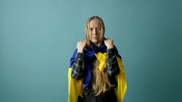 Young woman with Ukrainian flag on head 
