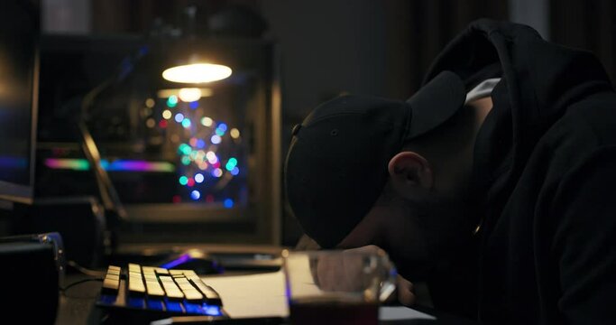 Student while studying for exams fell asleep at night on desk with cup of coffee, a man wakes up looking around confused rubbing eyes, a computer scientist looks at computer.