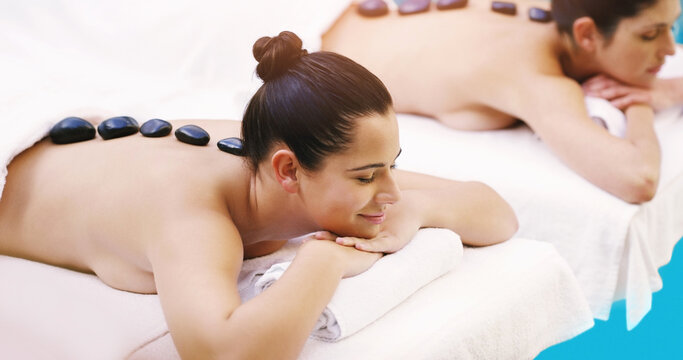 Today Is All About Taking Care Of Us. Shot Of Two Women Getting Hot Stone Massage At A Spa.