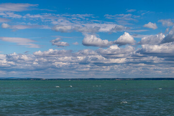 Balaton Lake in Siofok, Hungary. Dramatic Cloudy sky and blue, tourquise water.