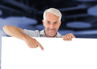 Caucasian senior man holding a placard with copy space against office in background