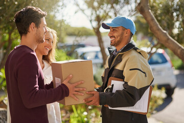 Delivery right to your door. Shot of a courier delivering a package to a smiling young couple at home.