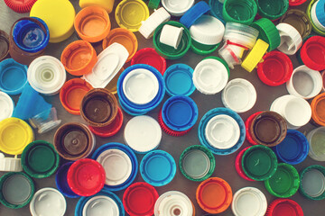 Collection of plastic caps for recycling. Background image, ecological concept