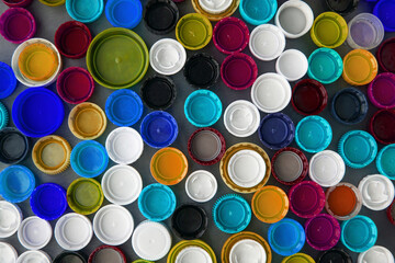 Wall background of plastic caps for recycling. Background image, ecological concept