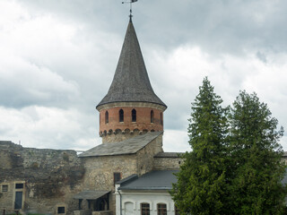 Fototapeta na wymiar Kamianets Podilsky fortress on cloudy day in Khmelnytskyi Region, Ukraine. Rozanka Tower, also known as the Burgrabska or Kreslavska Tower, which was constructed between the 14th and 16th centuries