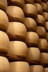 Fototapeta na wymiar Process of making parmigiano-reggiano parmesan cheese on small cheese farm in Parma, Italy, factory maturation room for aging of cheese wheels up to 5 years