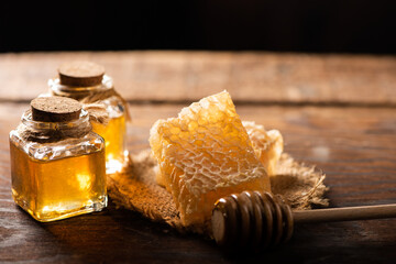 Homemade honey with honeycomb on a rustic wooden table